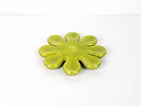 Top view of green ceramic flower-shaped trivet