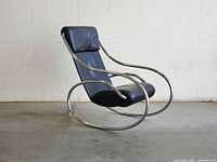 Front three-quarter view showing overall shape, leather and chrome frame