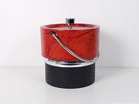 Front view showing red upper section, black lower section, chrome handle and knob