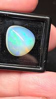 Freeform pear cabochon opal showing play-of-color