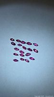 Group of 22 marquise rubies on white background