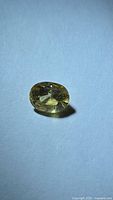 Front view of yellow sapphire showing oval cut and colour
