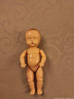 Full front view of Tudor Rose baby doll standing