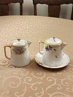 Front view of both Nippon creamers on table