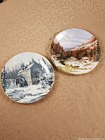 Two Royal Grafton Discover Canada collector plates showing winter scenes