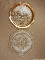 Top view showing both 12 in pressed-glass plates, amber and clear variants