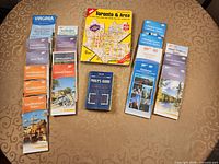 Front view showing eight AAA U.S. regional/state maps, MapArt Toronto atlas, Perly's Guide, and three additional Canadian city/province maps