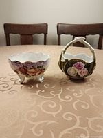 Tripod floral bowl and handled green floral basket on table