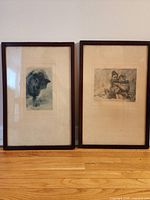 Two framed photogravure prints side by side showing subject images and framing