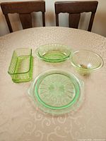 All four green uranium glass pieces displayed