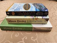Stack showing spines and titles of three Maeve Binchy paperbacks