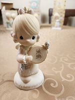 Full view of figurine front, showing subject and birds