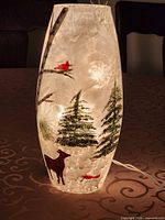 Vase illuminated showing painted winter scene
