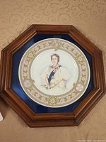 Framed commemorative plate showing portrait, border, frame detail