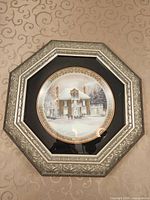 Front view showing plate artwork and octagonal frame