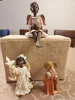 Front view of all three angel figurines on display block