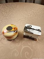 Both porcelain items side by side on table