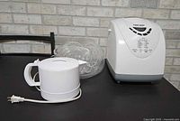 Breadmaker, kettle and nested bowls on table