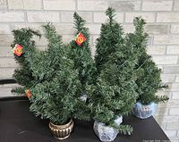 Group of artificial Christmas trees showing quantity and overall appearance