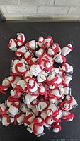 Pile of numerous felt penguin ornaments