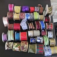 Full group of ribbon spools stacked on table