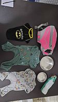 All items laid out showing life jacket, three garments, two bowls, travel bottle
