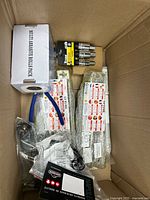 Top view of entire box showing all items including abrasive pack, Getime items, Titan set, pliers, cable
