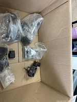 Overview of loose and bagged mounting brackets inside box