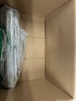 Open box showing shrink-wrapped component