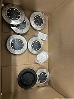 Solar LED disks and accessories in box