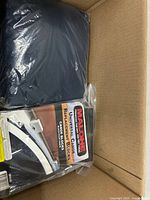 View of navy nylon fabric cover and packaged Malone canoe replacement blocks inside box