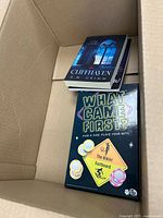 Overview showing two Cliffhaven books and What Came First? board game in box