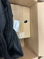 Box interior showing clamp and cardboard divider