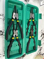 Open case showing four snap ring pliers
