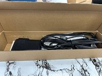 Open box showing power adapter, cable, and packaged light bar