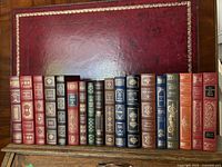Front spines of all 18 Franklin Library books lined up