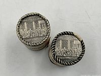 Two coin rolls showing reverse coin design and crimped ends