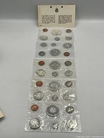 Five sealed Canadian mint sets laid out with information card