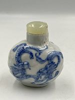 Front view showing blue dragon motif and stopper