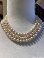 Necklace front view on bust showing three strands of pearls