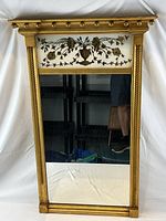 Front view showing full mirror, frame, eglomise panel