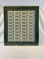 Full view of framed uncut banknote sheet