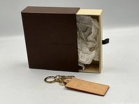 Keychain displayed beside original Louis Vuitton box