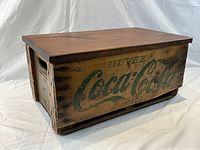 Three-quarter view of closed crate showing logo and lid