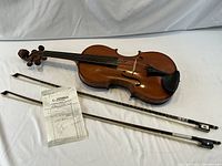 Violin, two bows and receipt laid out