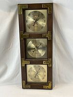 Full view of wooden weather station with three gauges