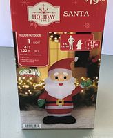 Front of boxed Holiday Time 4 ft inflatable Santa