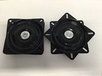 Two black swivel plates front view