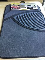 Full view of carpeted floor mat set with packaging