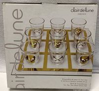 Front of boxed Clair de Lune tic-tac-toe shot glass set